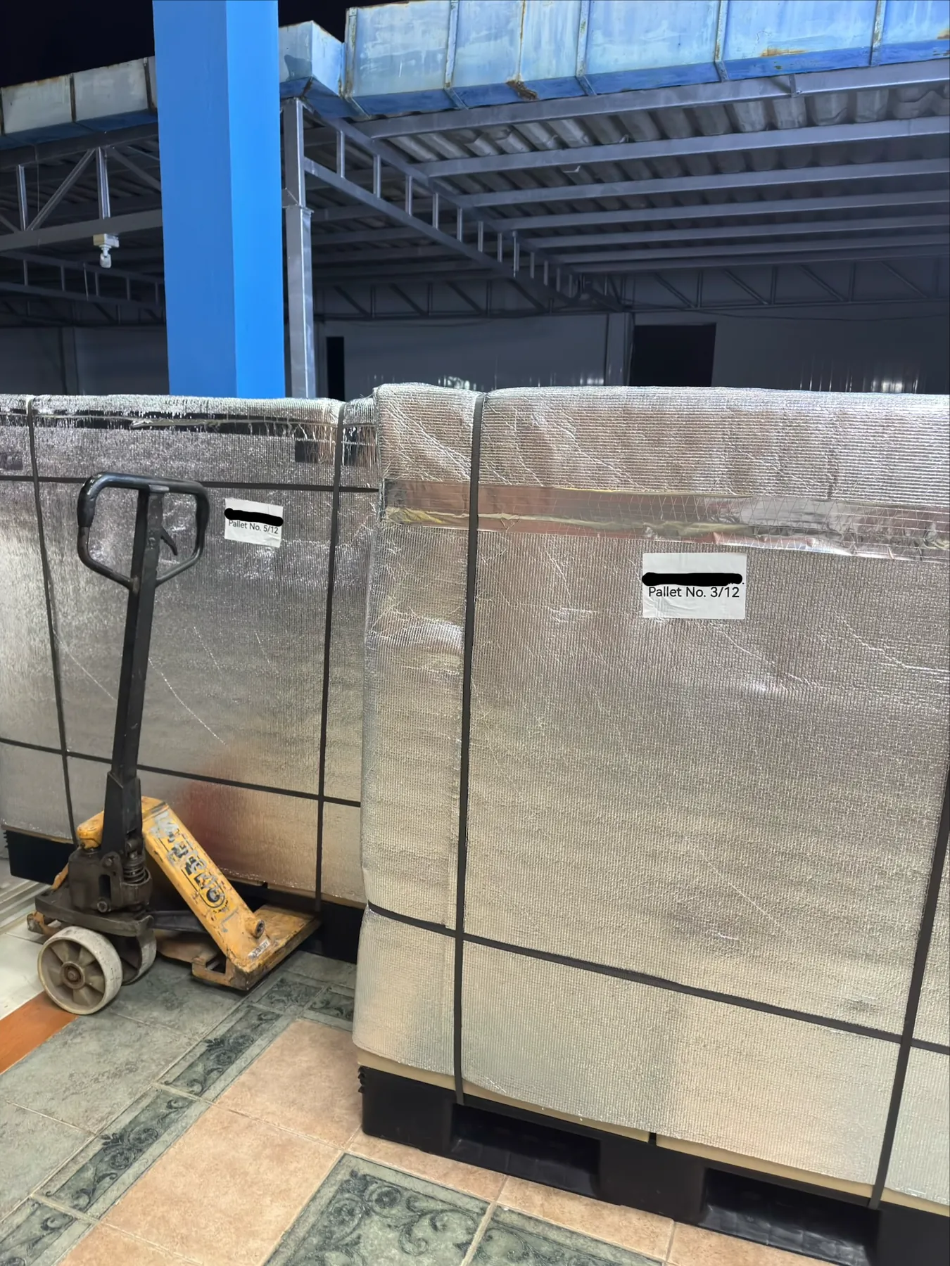 Pallet jack moving a strapped and wrapped export pallet